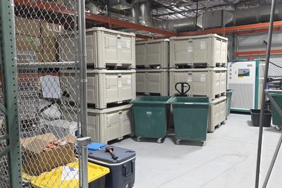 Secured storage bay with pallet totes and process chiller